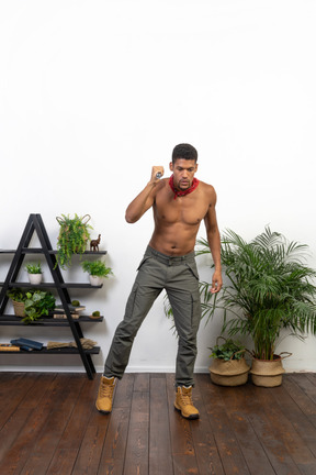 Good looking athletic man holding flashlight