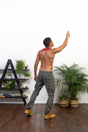 Good looking athletic man holding flashlight